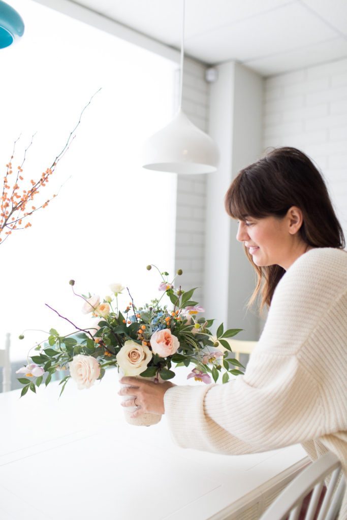 Jillian Harris adding flowers in the Mamas For Mamas Charity boardroom