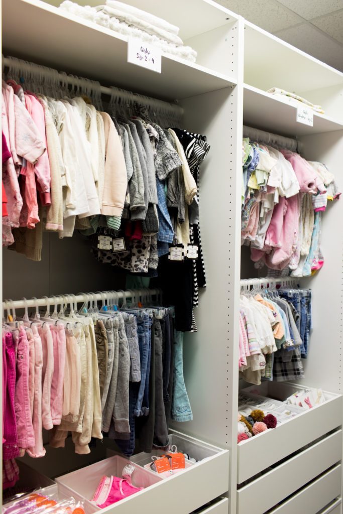 Little girls clothing in the closet space at the Mamas For Mamas charity headquarters