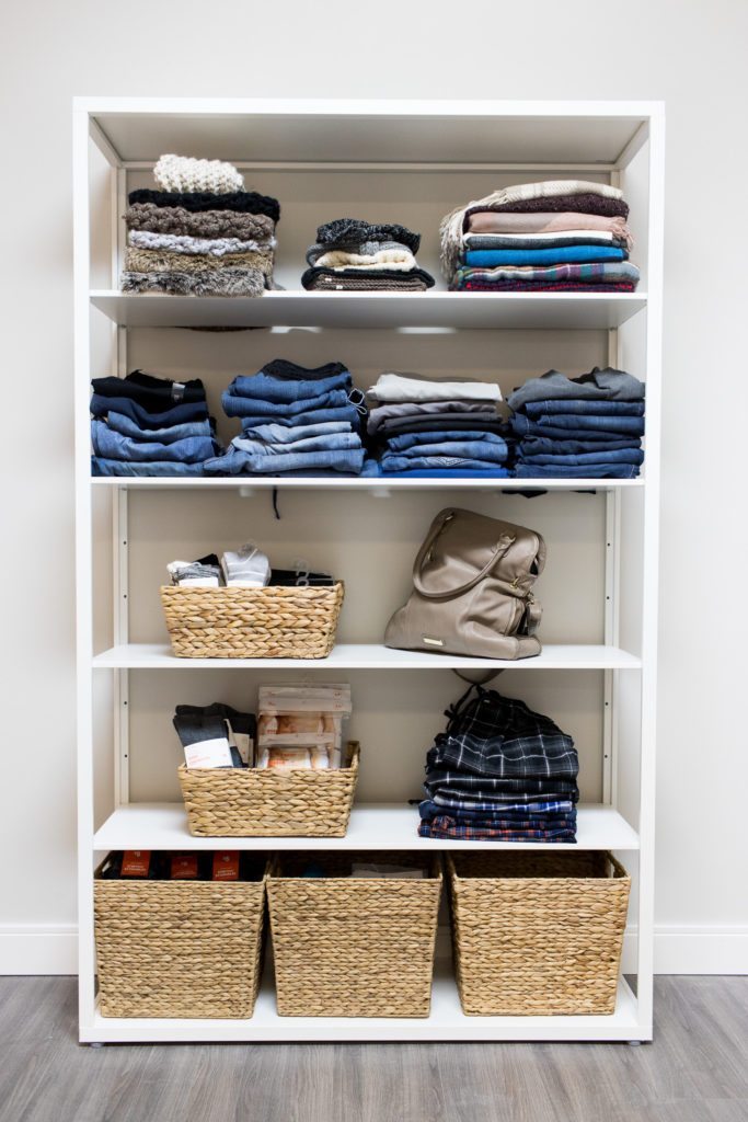 A selection of donated products at Mamas For Mamas charity including blue jeans, beanies and a tan handbag