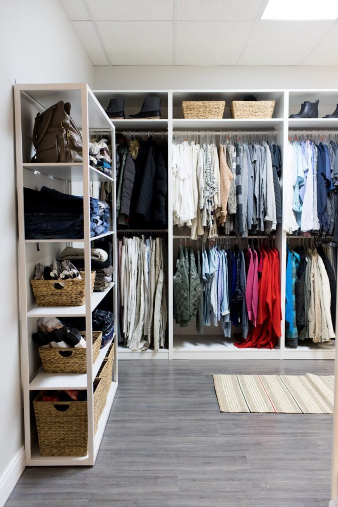 a selection of donated clothing items for adults including pants and shirts.